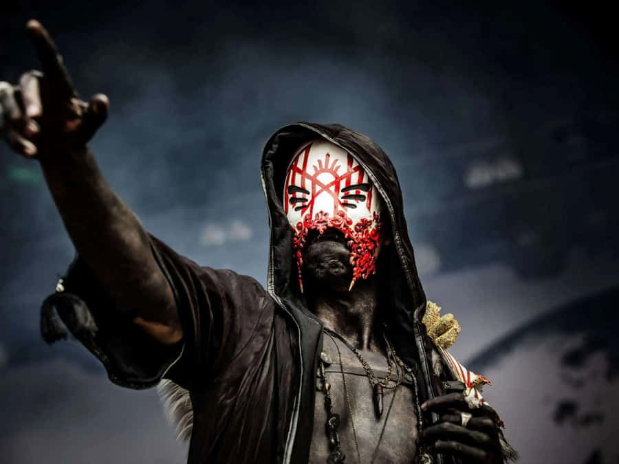 Mystic Figurewith Maskand Raised Hand Wallpaper