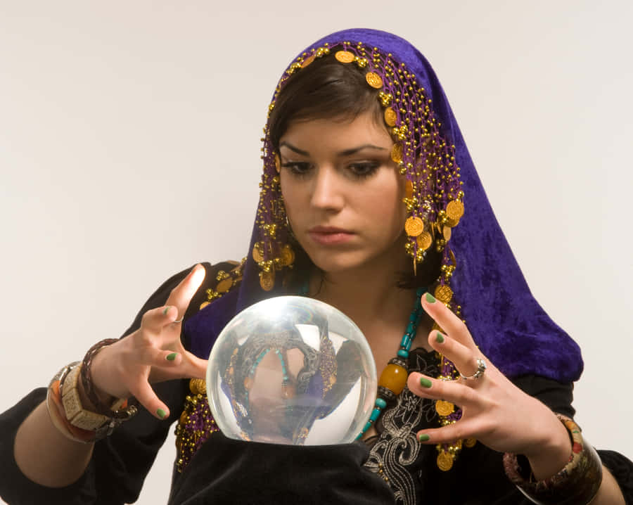 Mystical Fortune Teller Gazing At Crystal Ball Wallpaper