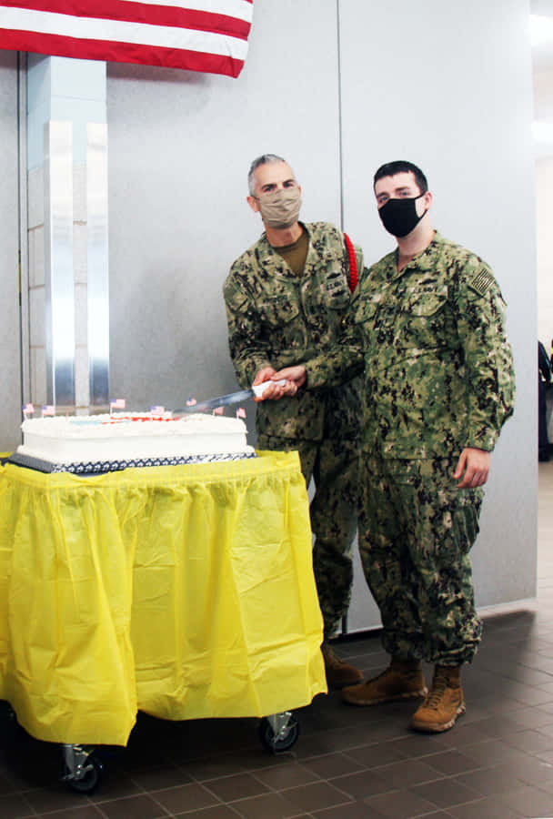 Navy Personnel Celebratingwith Cake Wallpaper