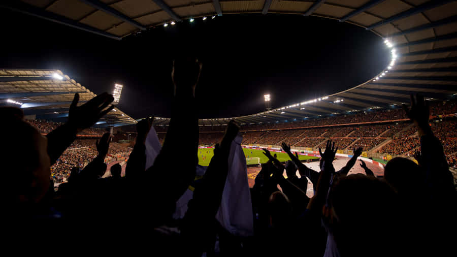 Nighttime Soccer Stadium Cheering Fans Wallpaper