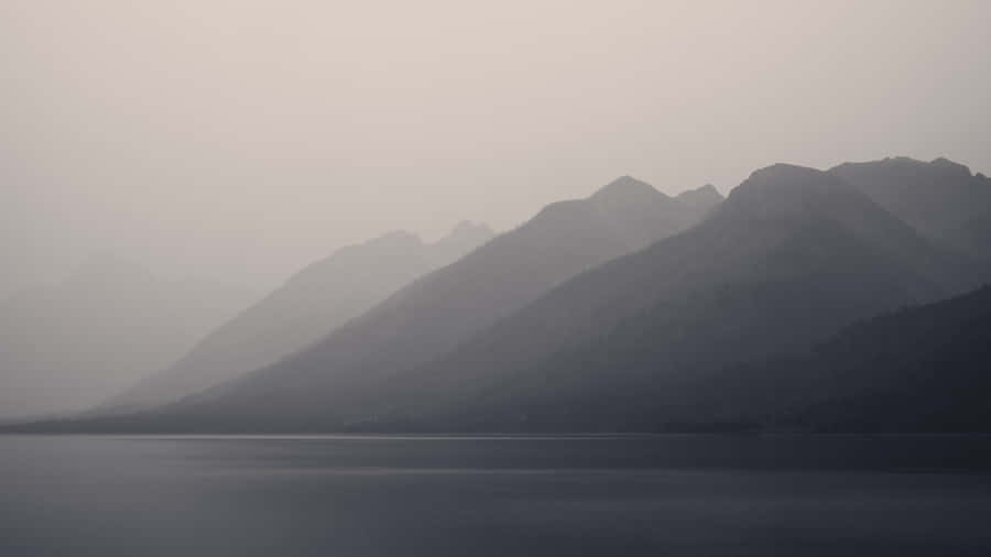 Obscure Foggy Mountains And Lake Wallpaper