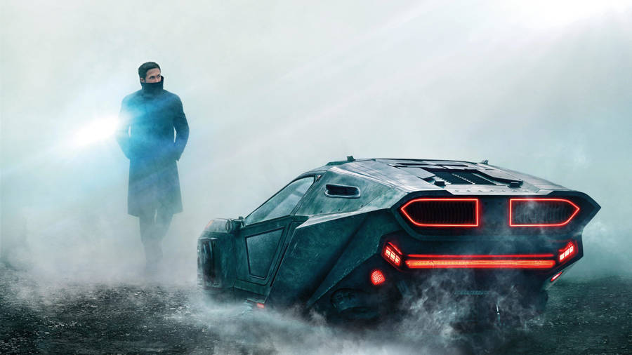 Officer K (ryan Gosling) In A Chase Scene From Blade Runner 2049 Wallpaper