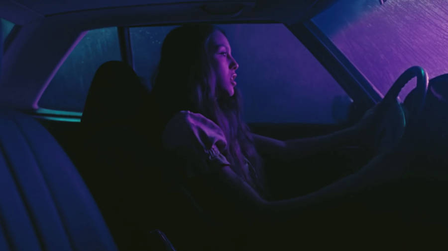 Olivia Rodrigo In Car Drivers License Wallpaper