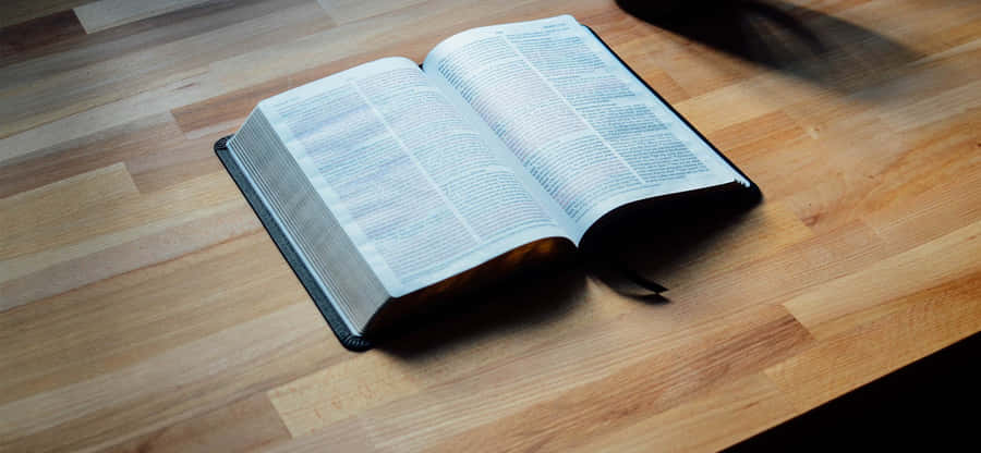 Open Bibleon Wooden Table Wallpaper