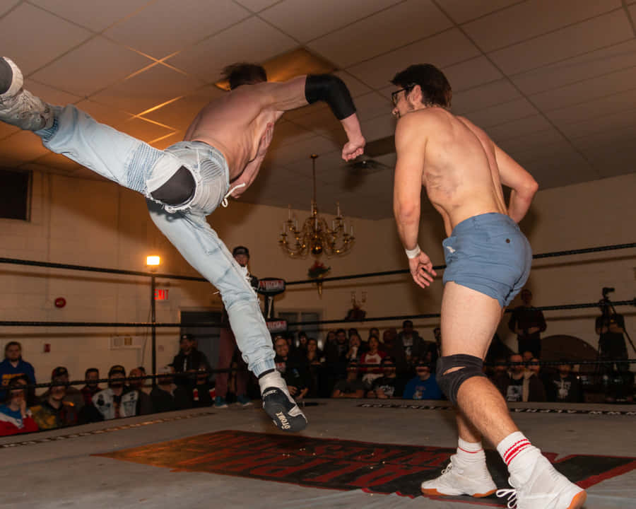 Orange Cassidy Delivering A Superman Punch In Pro Wrestling Match Wallpaper