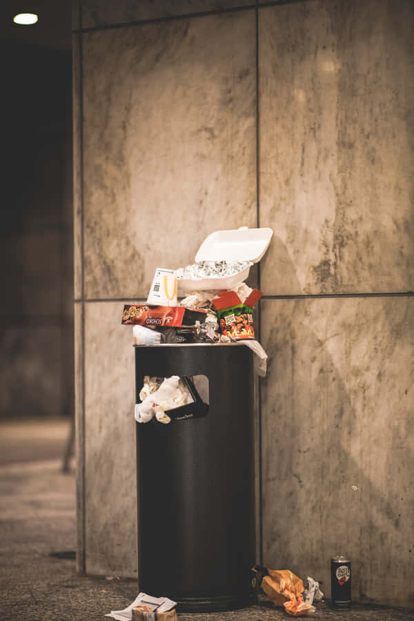 Overflowing Black Trash Can Wallpaper