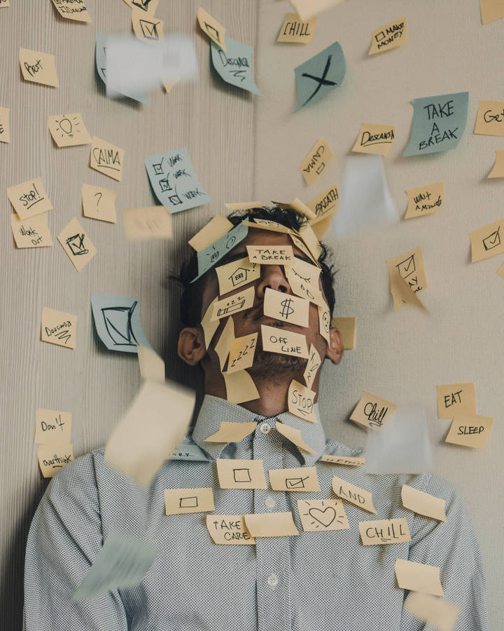 Overwhelmed Man Engulfed In Post-it Tasks Wallpaper