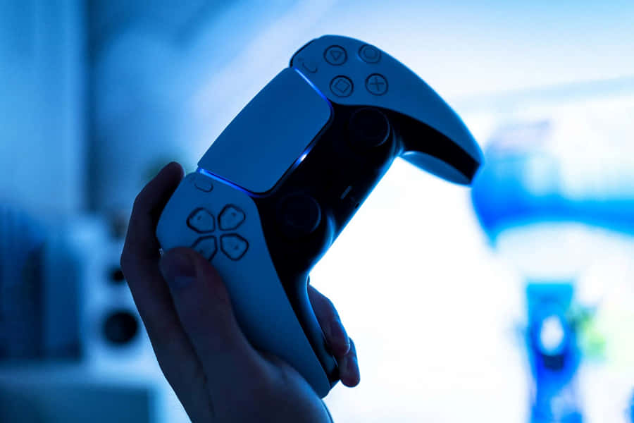 P S5 Controller In Hand Wallpaper
