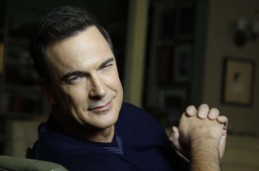 Patrick Warburton Looking Intense In Blue Shirt Wallpaper