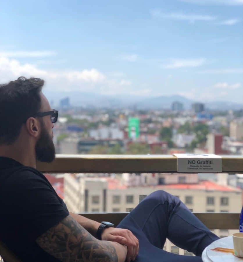 Paul Craig Relaxing On Balcony Wallpaper