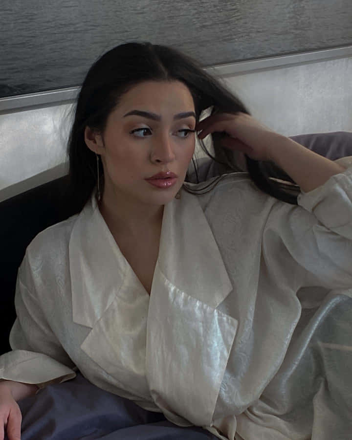 Pensive Womanin White Blouse Wallpaper