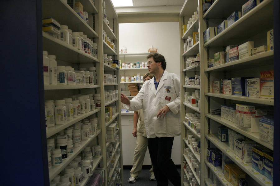Pharmacist Looking Over Medicines Wallpaper