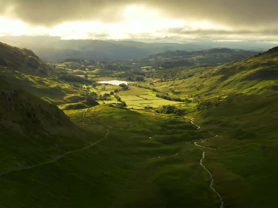 Picturesque Landscape Of The Rolling Hills Of A Pristine Valley Wallpaper