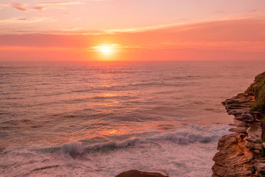 Pink Orange Sunset Over Sea Cliffs Wallpaper