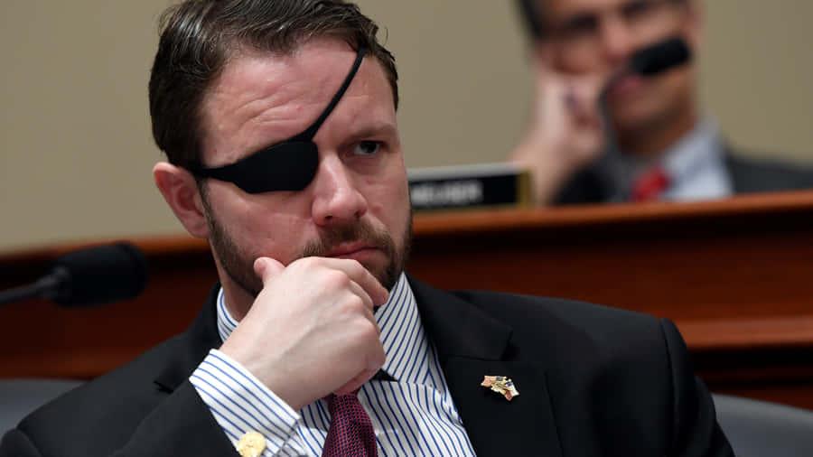 Politicianwith Eyepatchin Thoughtful Pose Wallpaper