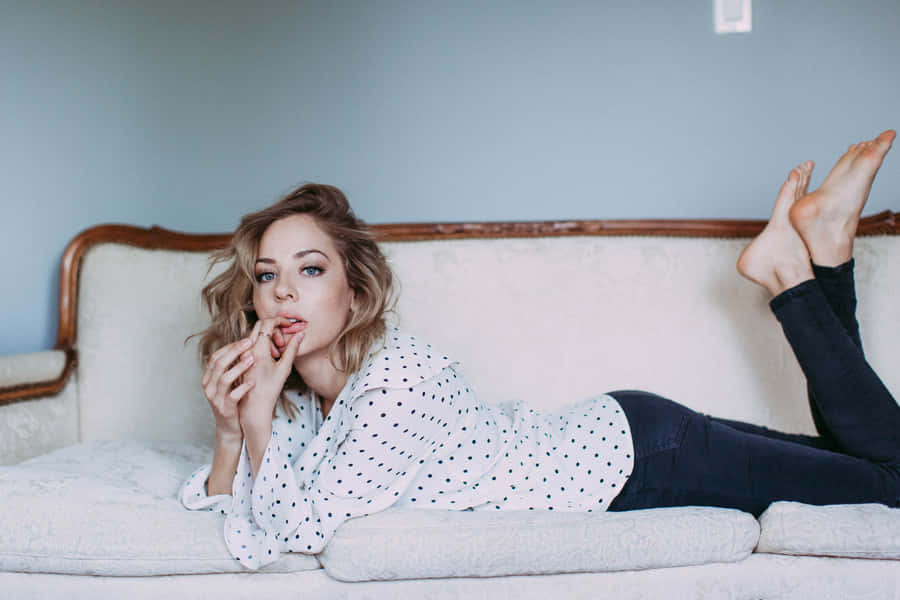 Polka Dot Shirt Woman Lying On Couch Wallpaper