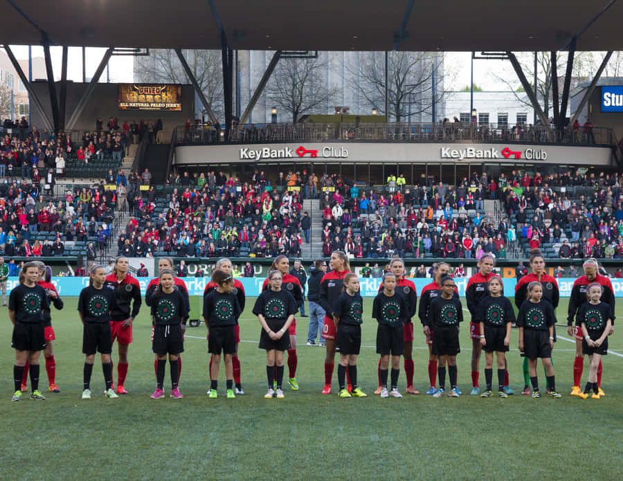 Portland Thorns Fc Players Celebrating A Victory Wallpaper