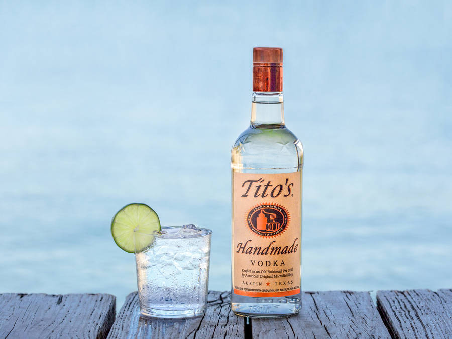 Premium Tito's Vodka Served With A Fresh Lime Slice Wallpaper