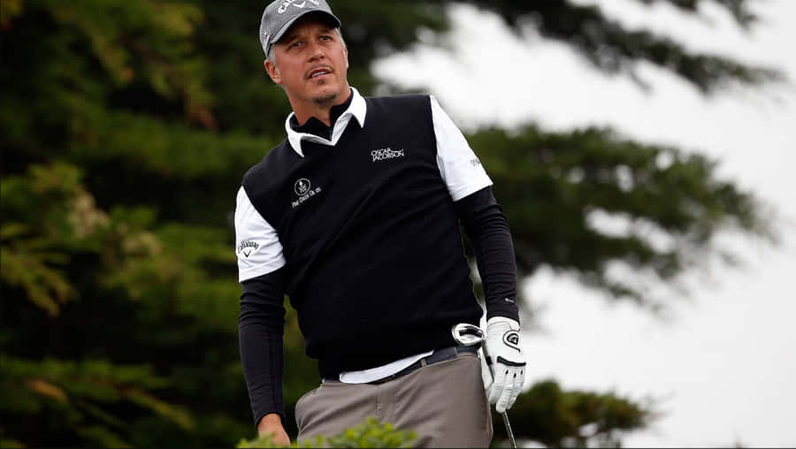 Professional Golfer Freddie Jacobson Skillfully Holding A Golf Club. Wallpaper