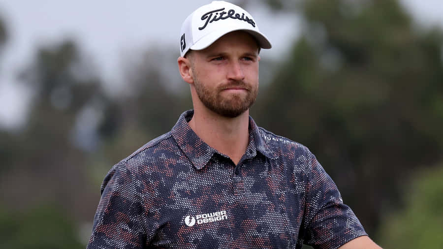Professional Golfer Wyndham Clark In Full Swing Wallpaper