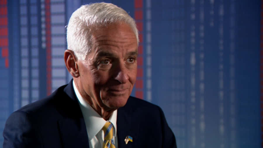 Professional Portrait Of Charlie Crist Against A Blue Background Wallpaper