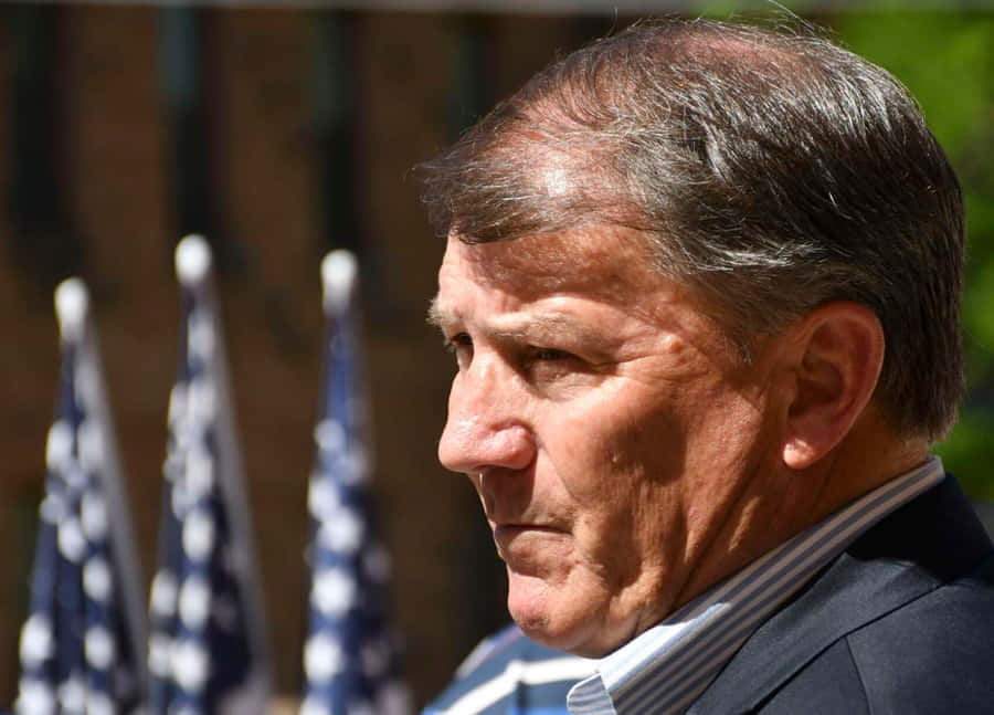 Profileof Manwith Flags Background Wallpaper