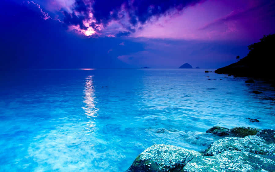 Purple Sky Over Serene Crystal Clear Water Wallpaper