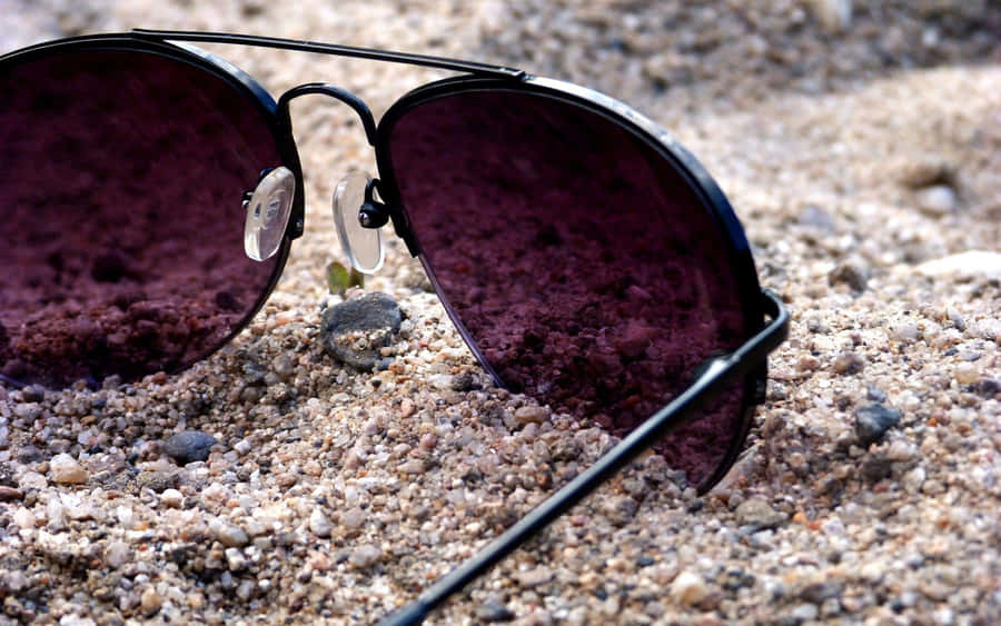 Purple Sunglasseson Sandy Beach Wallpaper