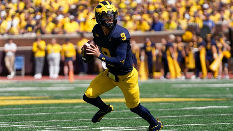 Quarterback In Actionat Football Game Wallpaper