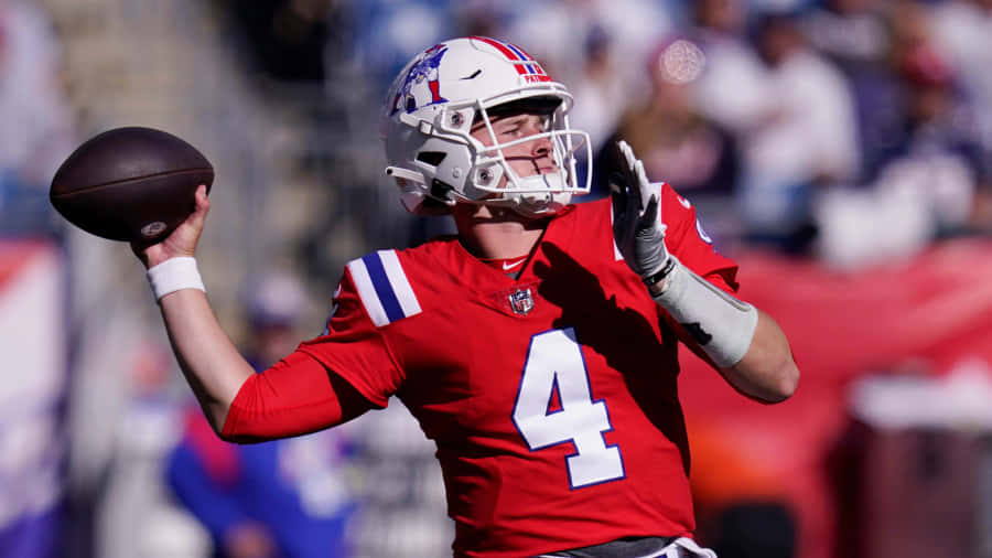 Quarterback Number4 Throwing Football Wallpaper