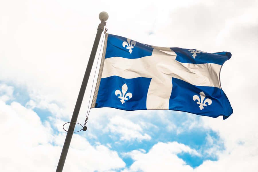 Quebec_ Fleurdelise_ Flag_ Waving Wallpaper