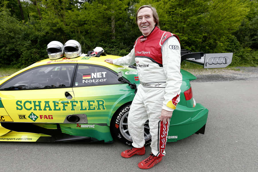 Racing Driver Smiling Beside Audi Race Car Wallpaper