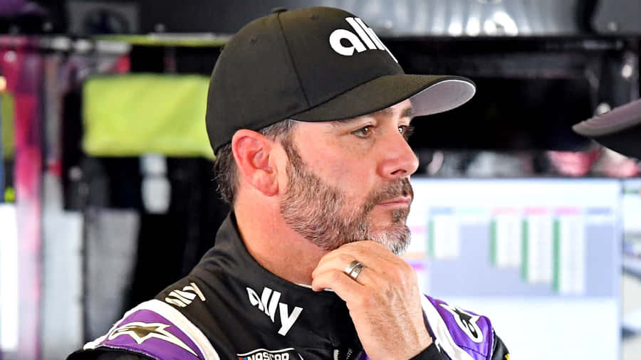 Racing Legend Jimmie Johnson In Action On The Track Wallpaper
