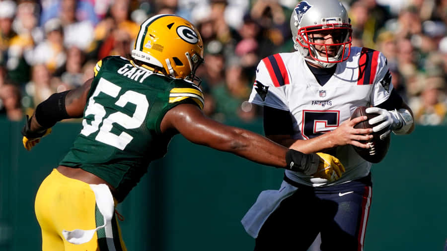 Rashan Gary Pursuing Opponent Quarterback Wallpaper