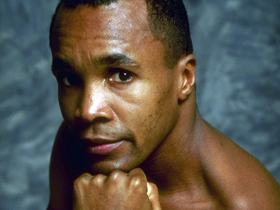 Ray Leonard Posing In Front Of Blue Backdrop Wallpaper