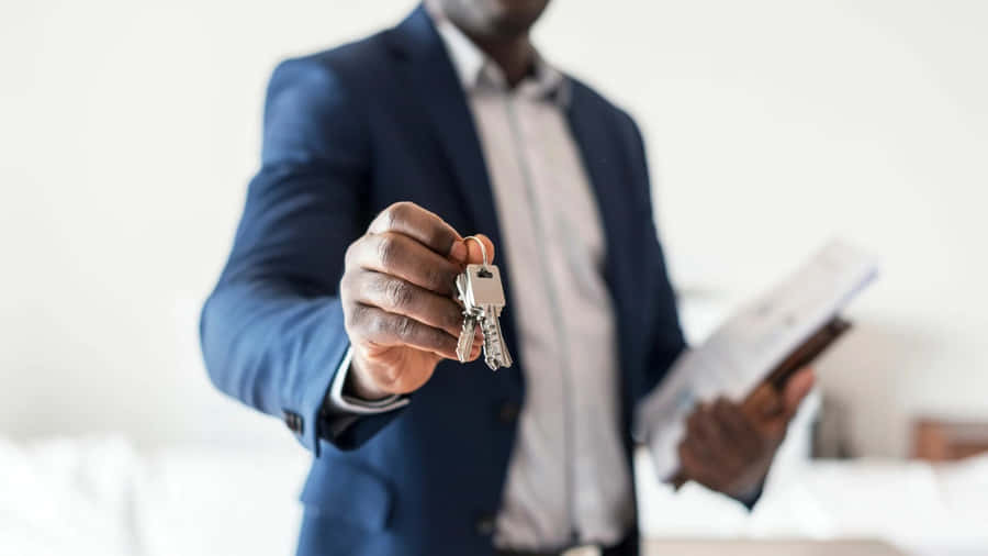 Real Estate Agent Offering House Keys Wallpaper