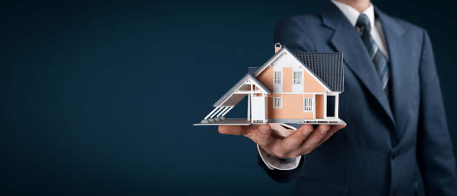 Real Estate Agent Presenting House Model Wallpaper