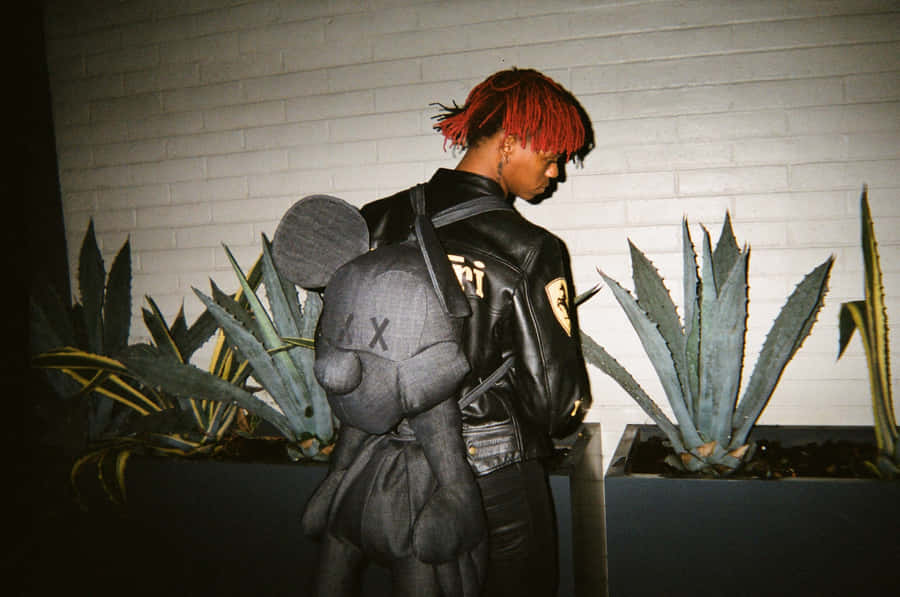 Red Haired Manwith Plush Backpack Wallpaper