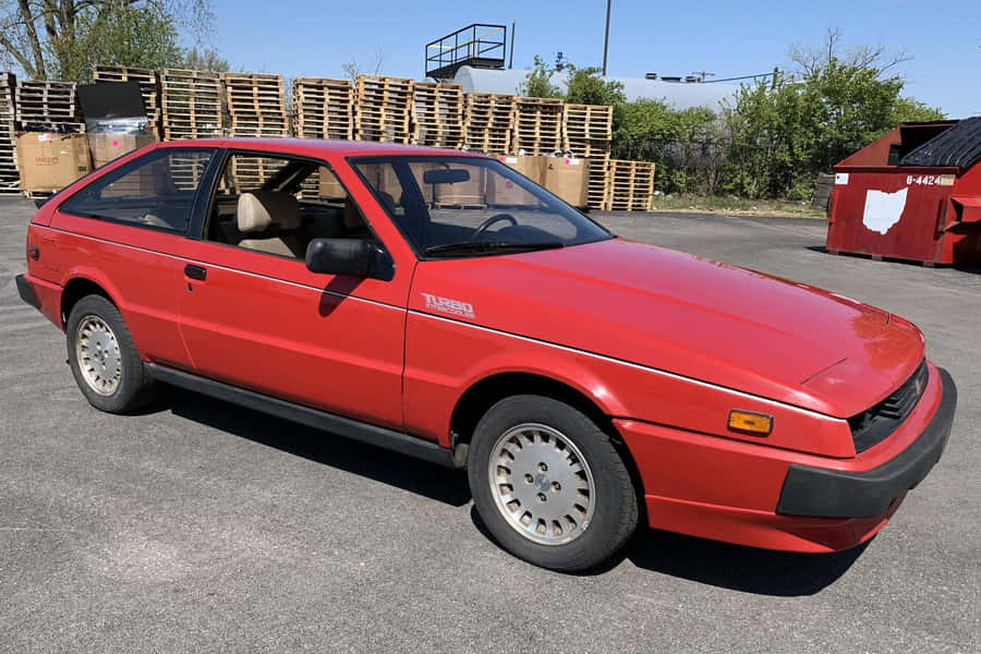 Red Isuzu Impulse Turbo Parked Outdoors Wallpaper