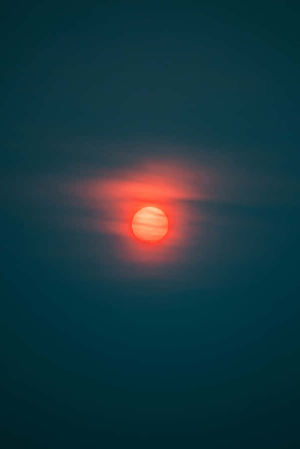Red Moon Glowing Through Haze Wallpaper