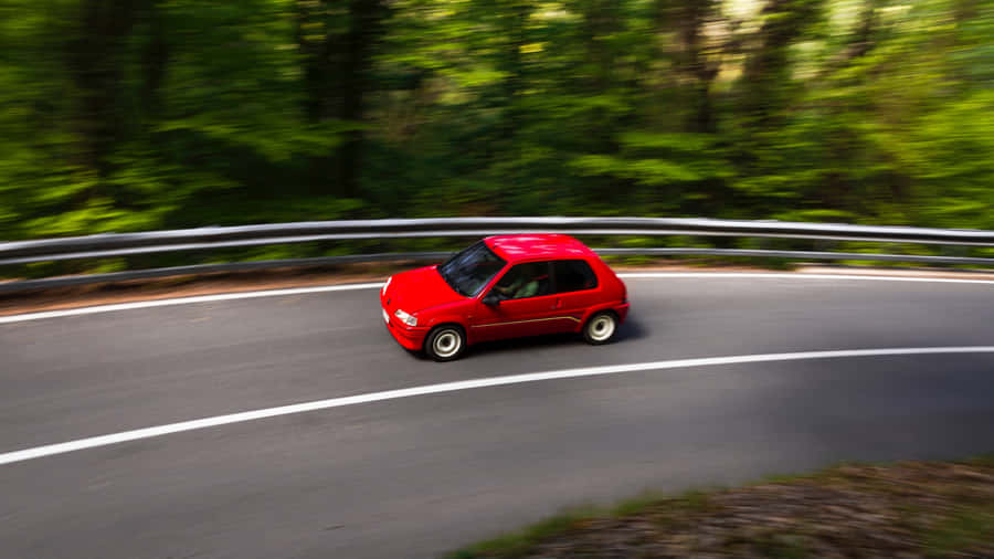 Red Peugeot106 Speedingon Country Road Wallpaper