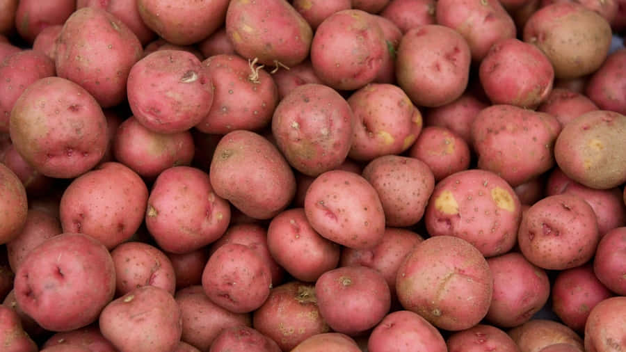 Red Potatoes On A Wooden Surface Wallpaper