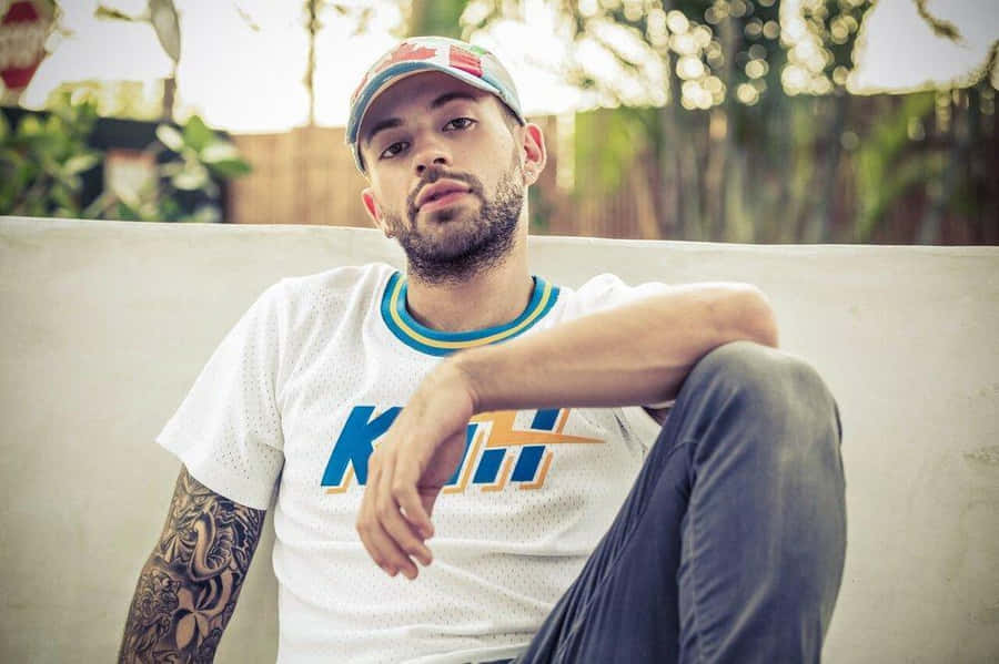 Relaxed Man Outdoor Sitting Wallpaper