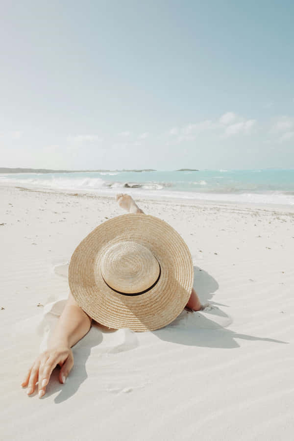 Relaxing Beach Day With Sunhat Wallpaper