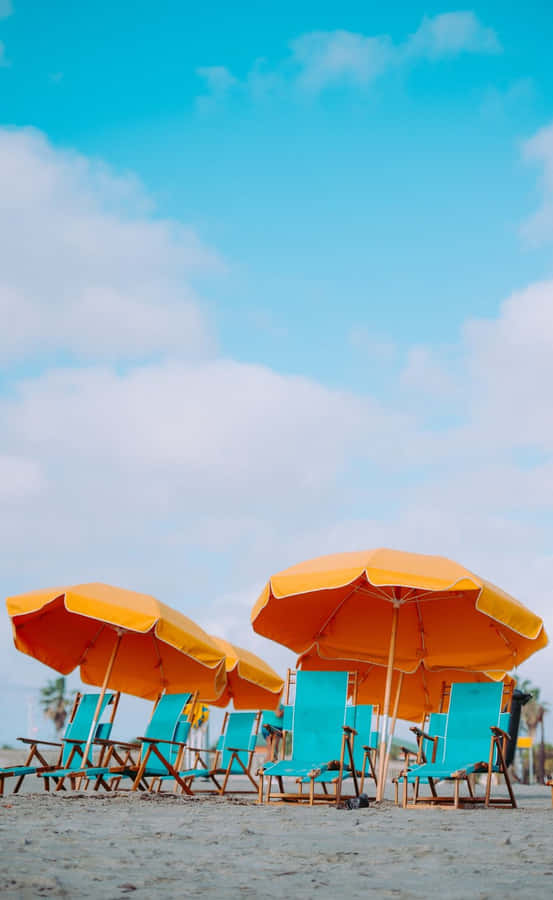 Relaxing Beach Scene With Colorful Umbrella Wallpaper
