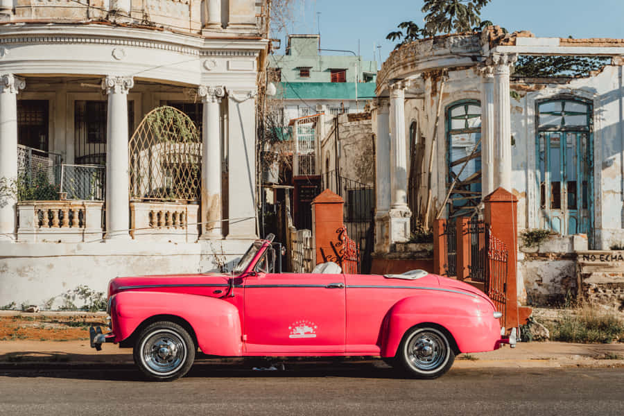 Retro And Stylish - A Breathtaking Pink Vintage Car Wallpaper