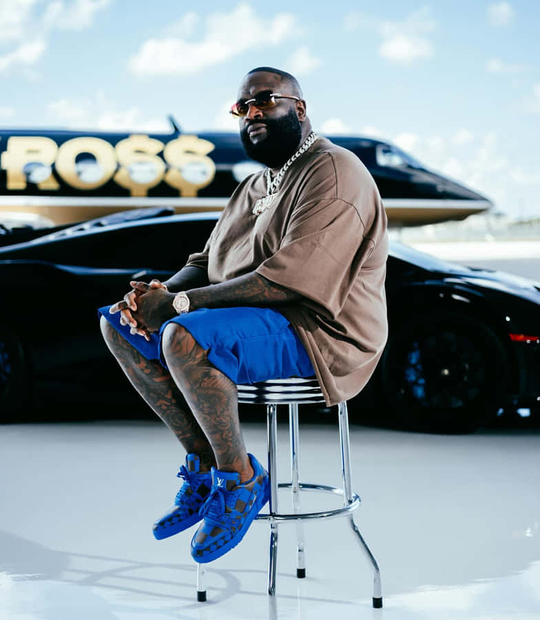 Rick Ross Stylish Pose With Cars And Jet Wallpaper