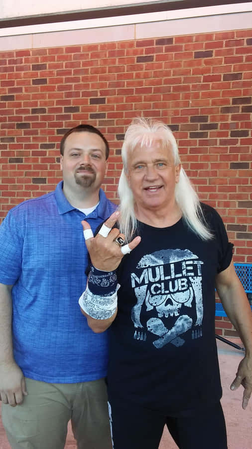 Ricky Morton Posing With A Fan Wallpaper