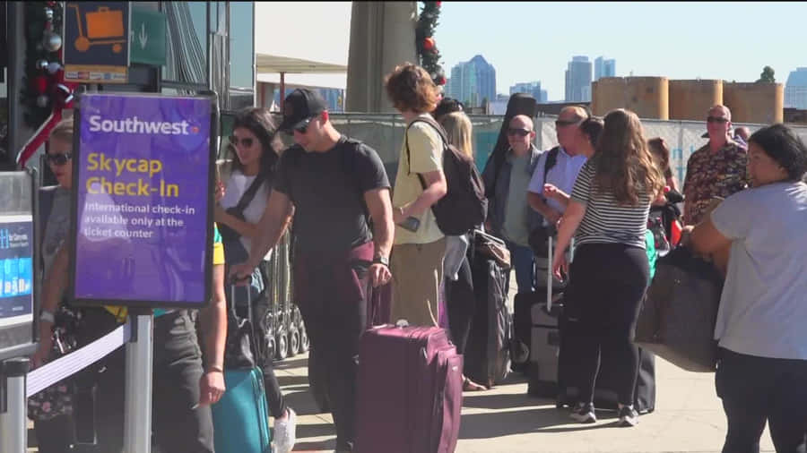 Rolling In Style With A Purple Travel Bag Wallpaper