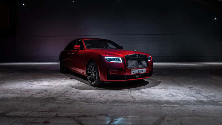 Rolls Royce Phantom - A Red Car In A Dark Room Wallpaper